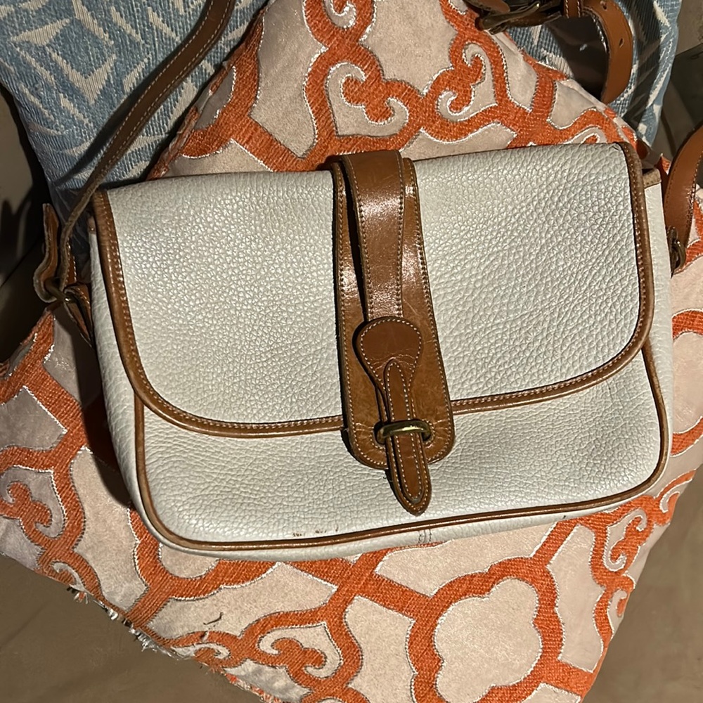 It’s a cream with brown, and is adjustable